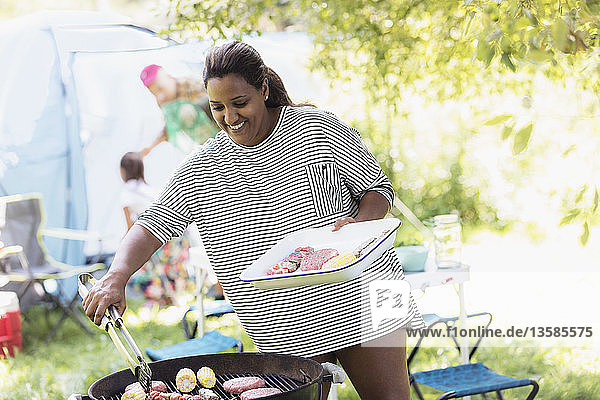 Woman barbecuing at campsite