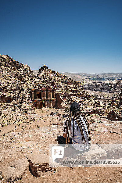 Male traveler with dreadlocks visiting ruins  Petra  Jordan