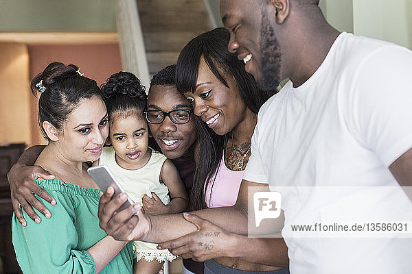 Lesbian couple and children using smart phone