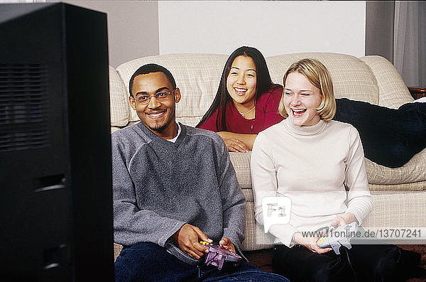 Three teens playing an interactive videogame.