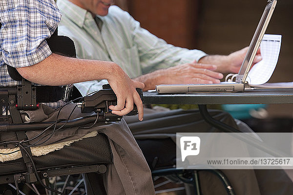 Disabled businessmen working on a laptop