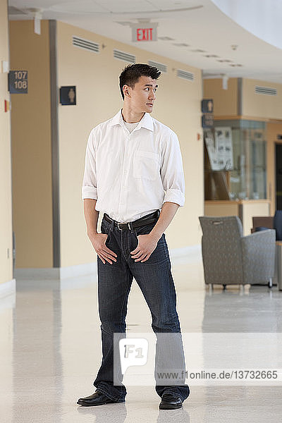 Student standing with hands in his pockets