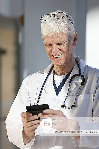 Doctor text messaging on his smartphone