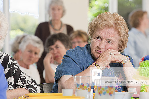 Senior woman relaxing at a luncheon