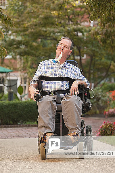 Man with a Duchenne muscular dystrophy sitting in a wheelchair