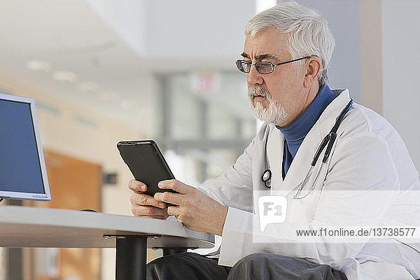 Doctor looking at his tablet