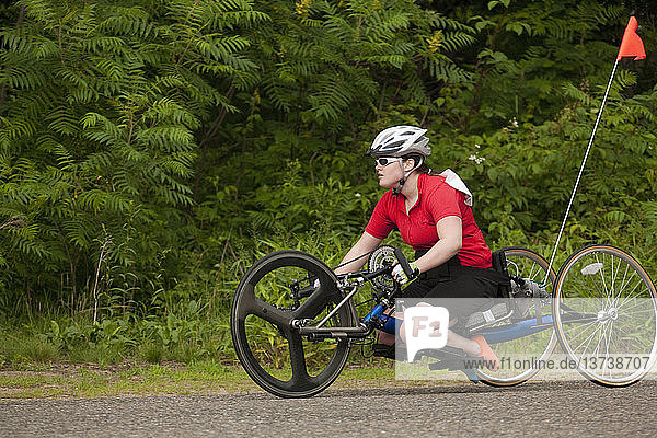 Woman with degenerative hip participating in a handcycle race