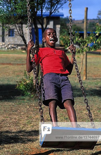 Boy swinging at Kip Keino´s orphanage   Eldoret  Kenya.