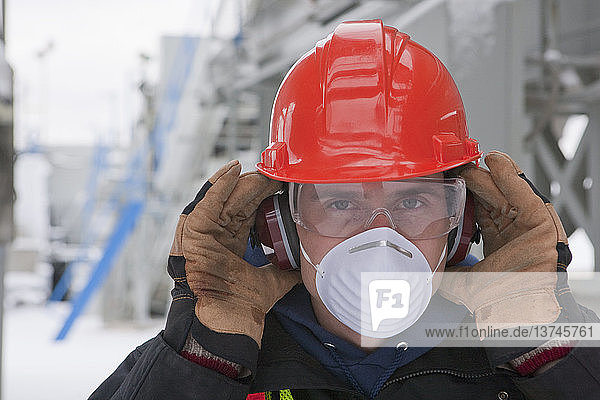 Engineer with protective mask and ear protectors