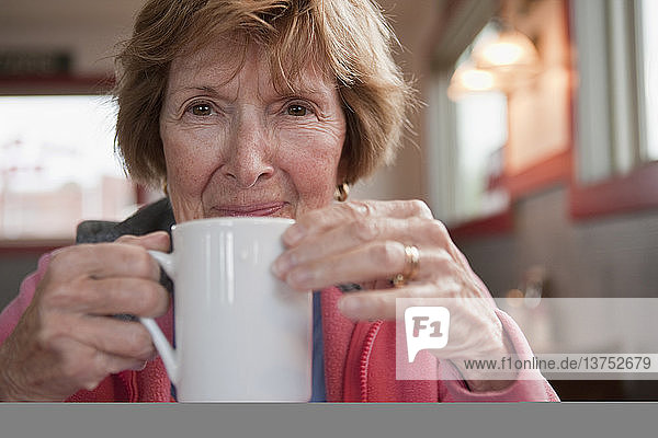 Frau trinkt eine Tasse Kaffee in einem Cafe