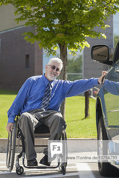 Mann mit Muskeldystrophie und Diabetes in einem Rollstuhl neben einem behindertengerechten Lieferwagen
