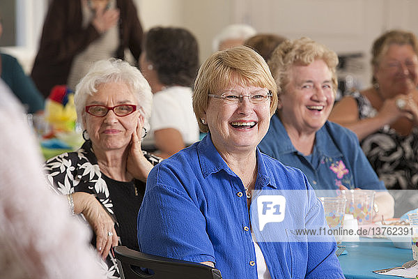 Senior women laughing at a luncheon