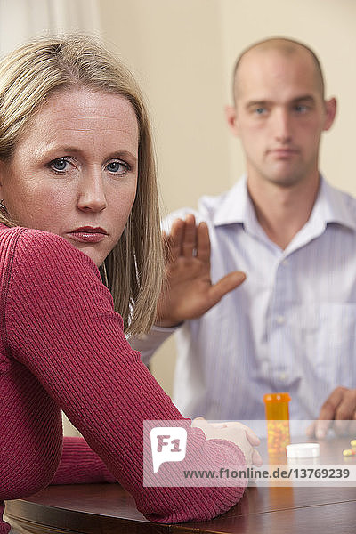 Man signing the word ´Yours´ in American Sign Language while communicating with a woman