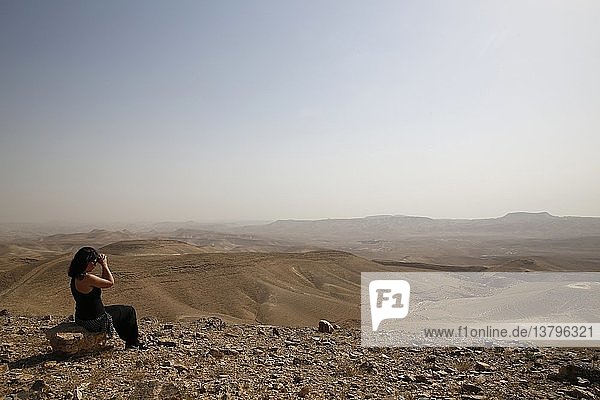 Pilgrimage in Holy Land  Woman praying in Judean desert.