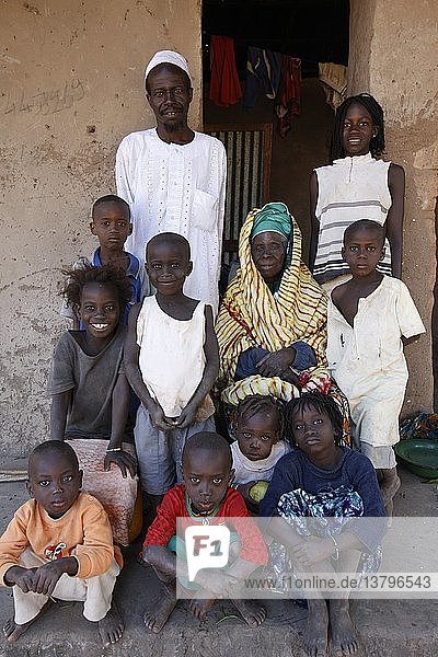 Family outside their home  Abene  Senegal.