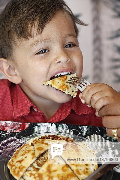 Boy eating pancakes  United States