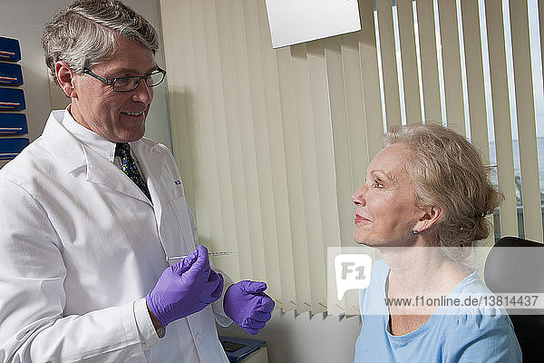 Ophthalmologist talking to a patient before giving Botox treatment