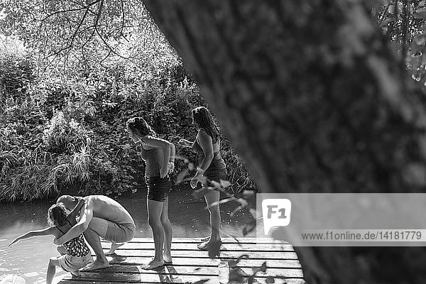Family on riverside dock