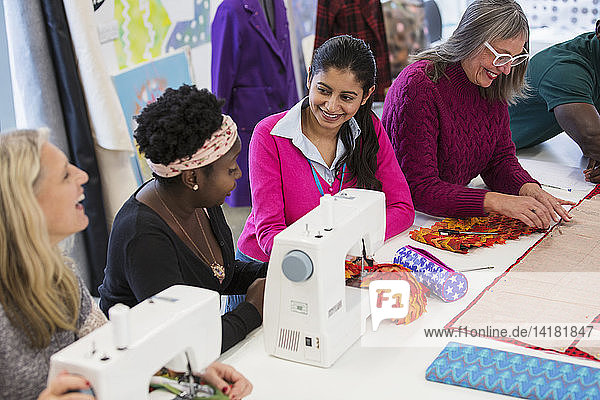 Fashion designers using sewing machines