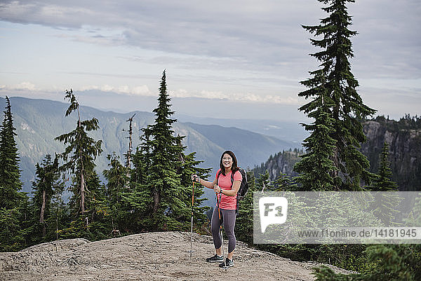 Portrait happy young woman hiking at mountaintop  Dog Mountain  BC  Canada