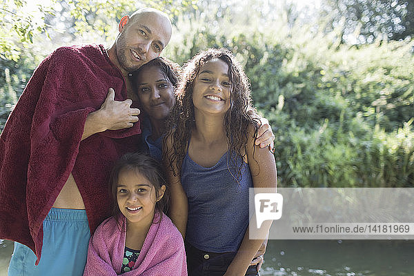 Portrait happy family at sunny riverside
