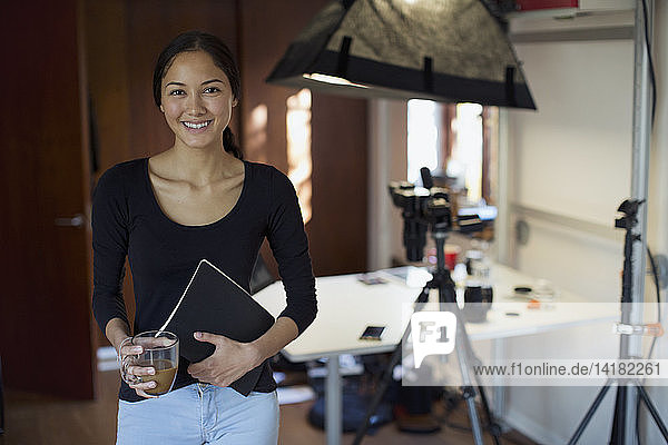 Portrait confident female photographer working in studio