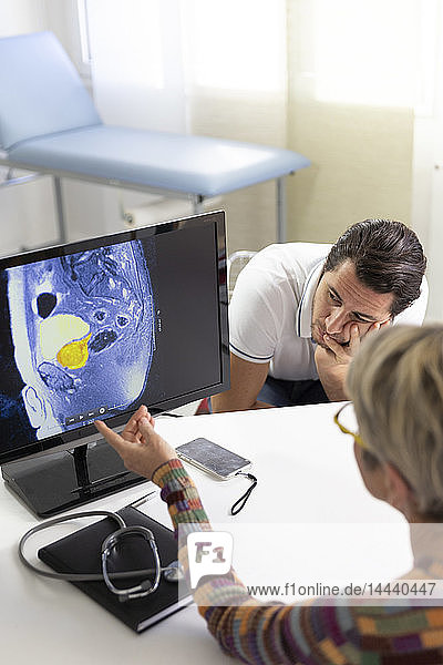 Man consulting a female doctor for prostate ultrasound examination.