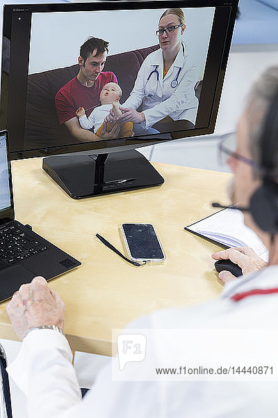 Pediatric video consultation involving a doctor and his colleague in the presence of the child and father.