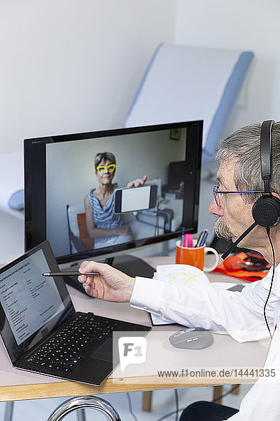 Videokonsultation zwischen einem Arzt und einer Patientin  die sich ihre medizinischen Tests erklären lassen möchte.