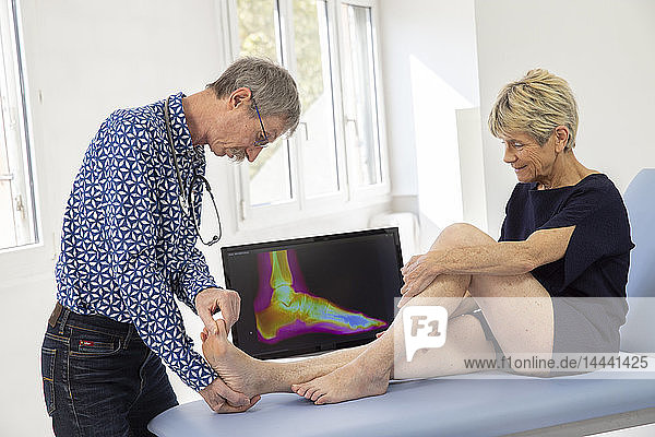 Woman consulting a doctor for a pain in her heel.