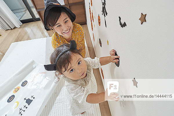 Japanese child and mother getting ready for Halloween