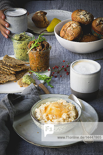Porridge with pear compote  crackers  tomato and pumpkin dip  pear muffins and a latte for breakfast