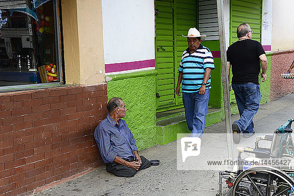 a disabled homeless man on a street in Copan  Honduras  Central America.