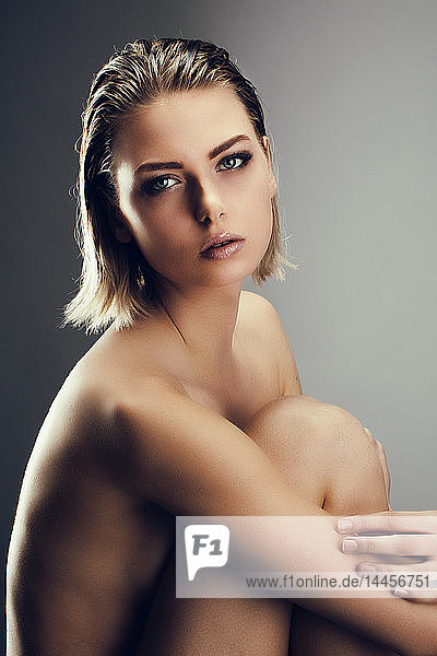 Portrait of a naked girl  looking towards the goal with beautiful eyebrows.
