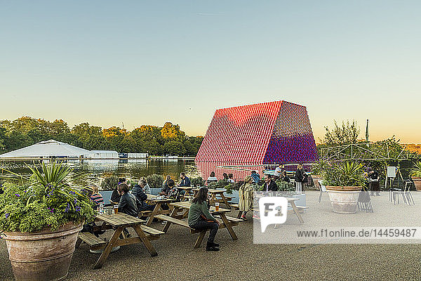 People relaxing in Hyde Park with The London Mastaba sculpture in the background  London  England  United Kingdom