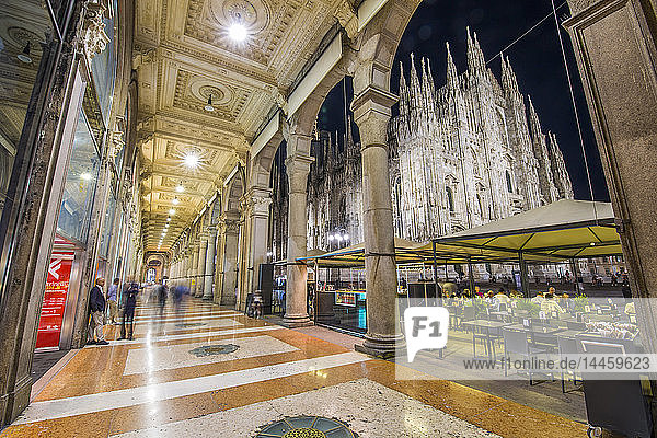 View of Duomo di Milano illuminated at dusk from Galleria Vittorio Emanuele II in Piazza Del Duomo at dusk  Milan  Lombardy  Italy
