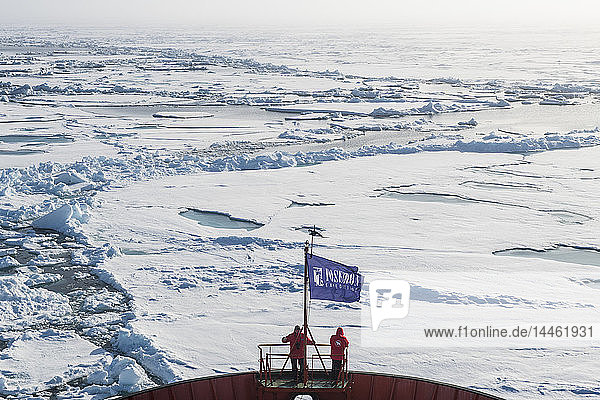 People enjoying the breaking ice on board of an icebreaker  North Pole  Arctic