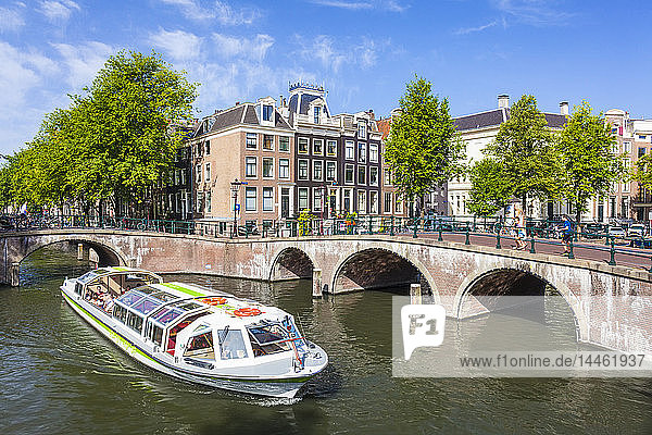 Canal tour boat and bridges at the junction of Leidsegracht Canal and Keizergracht Canal  Amsterdam  North Holland  Netherlands