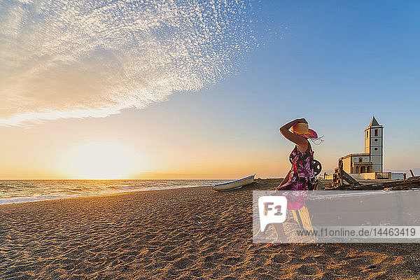 Woman on Iglesia de Las Salinas beach at sunset in Cabo de Gata-Nijar Natural Park  Spain