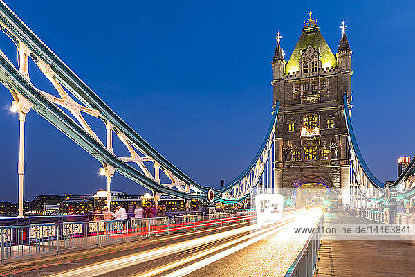 Light trails on Tower Bridge at sunset in London England