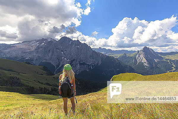 Girl looks towards Marmolada from Viel del Pan path  Pordoi Pass  Fassa Valley  Trentino  Dolomites  Italy