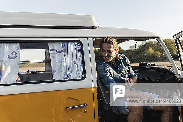 Young man on a road trip with his camper  taking a break