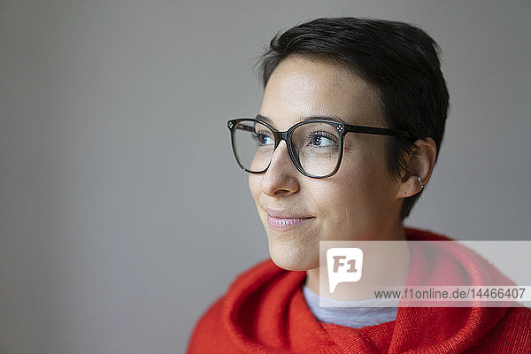 Portrait of a smiling young woman with short hair  wearing glasses