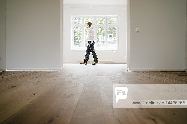 Businessman walking in empty flat