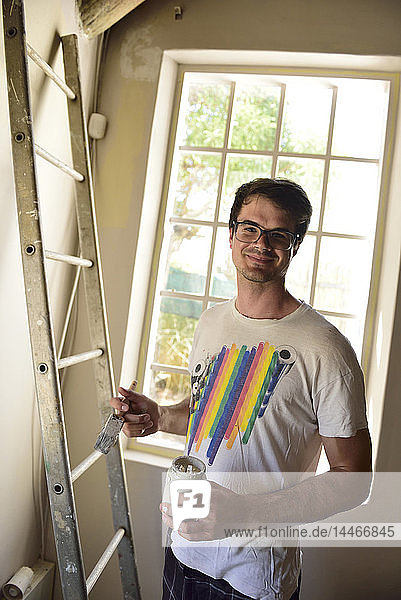 Portrait of smiling young man renovating his home