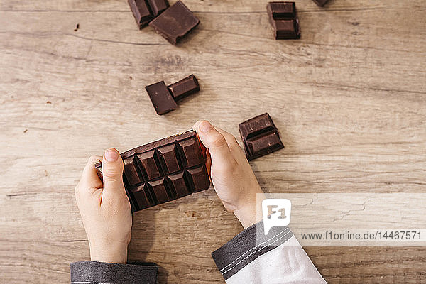 Boy's hands holding chocolate bar  close-up