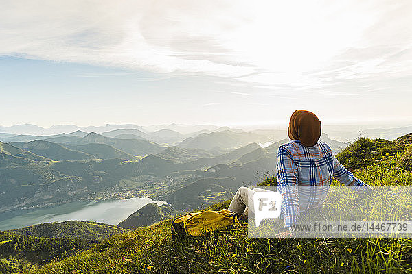 Austria  Salzkammergut  Hiker taking a break  looking over the Alps