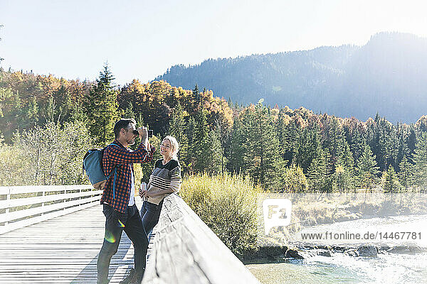 Austria  Alps  couple on a hiking trip with man looking through binoculars