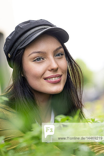 Portrait of a young woman with cap  smiling