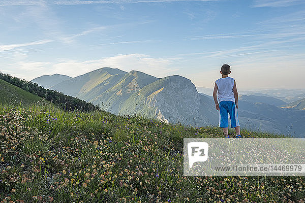 Italy  Umbria  Apennines  back view of boy standing on Monte Catria looking at view